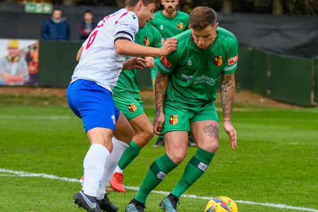Alex Collard challenges an Alvechurch opponent during AFC Rushden & Diamonds' 2-1 home defeat last Saturday. Picture courtesy of Hawkins Images