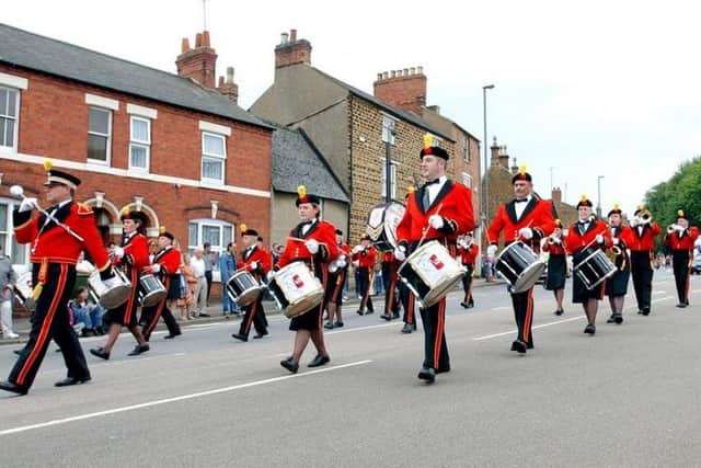 Wellingborough Redwell Band march down from Broad Green