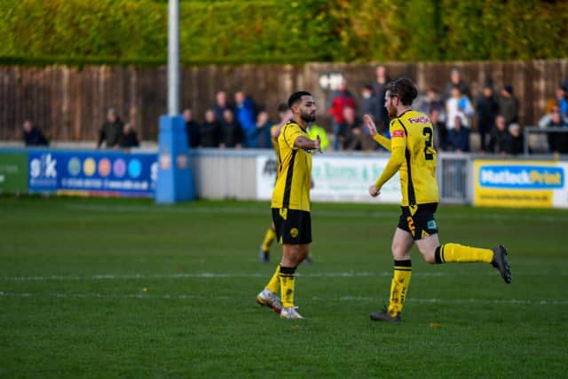 Ravi Shami is congratulated by Patrick Casey after he scored for Diamonds in the FA Trophy loss at Matlock