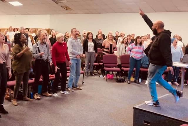Founder of the NSO Choir, Gareth Fuller, leading the Choir in practice.