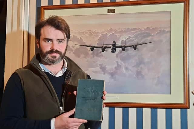 Hansons’ valuer Oliver Thomas with the flying log book.