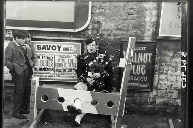 A piper plays in the stocks in 1962