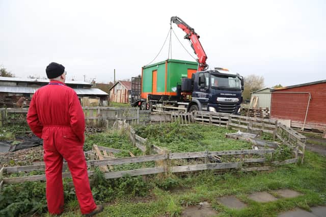 Lee watches the new unit being craned into place