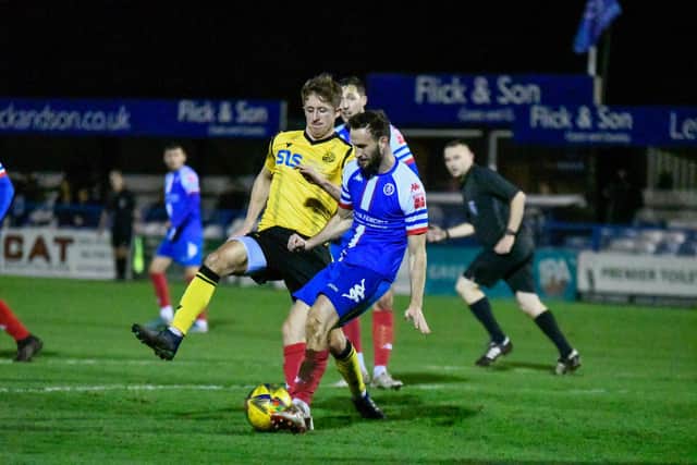 Ben Diamond challenges a Leiston opponent