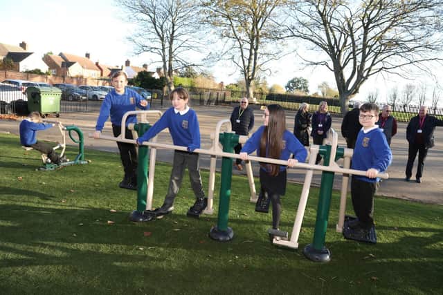 Pupils enjoying the outdoor gym equipment