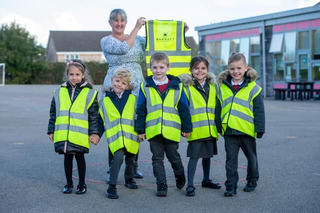 Claire Johnson and the children with their high vis vests