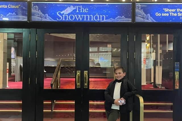 Jax on the steps of the theatre where he is performing