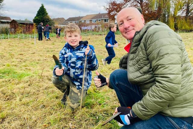 Rowan with grandad Clive Shackleton planting a rowan tree