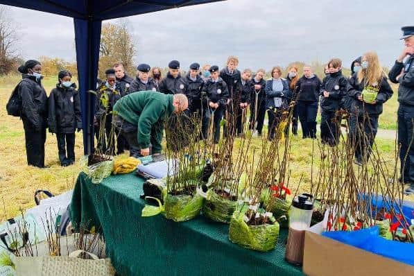 Lewis Mitchell, park ranger at Wicksteed Park, instructing the Emergency Services Cadets on how to correctly plant a sapling