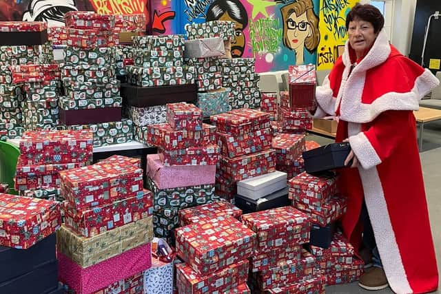 Jeanette Walsh - Mother Christmas - with some of the shoe boxes full of gifts collected by staff at Nando's