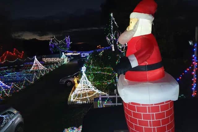Father Christmas perched on a chimney admiring the lights
