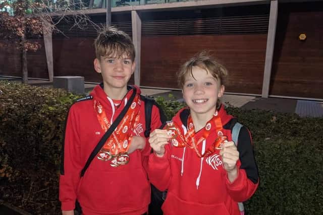 Siblings Fin and Islay-Mae with their medals