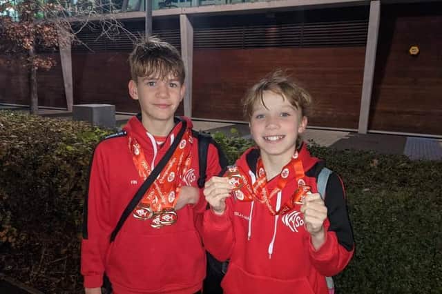 Siblings Fin and Islay-Mae with their medals