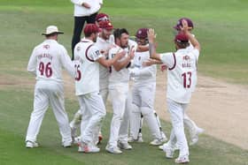 Simon Kerrigan (centre) is mobbed after claiming a wicket for Northants against Yorkshire last season