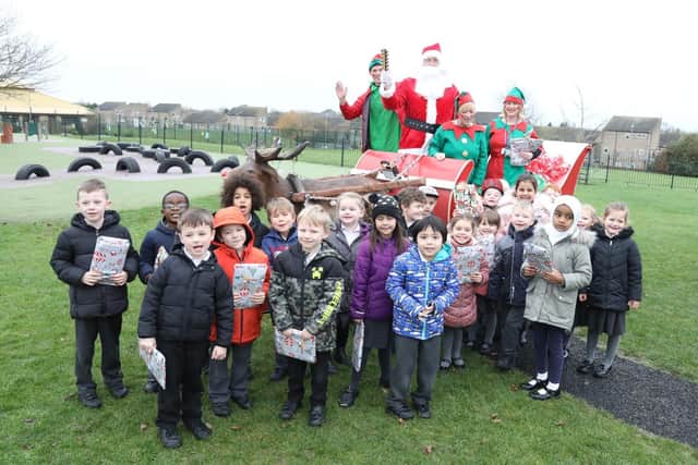Corby, Kingswood Primary Academy students with Santa and his elves