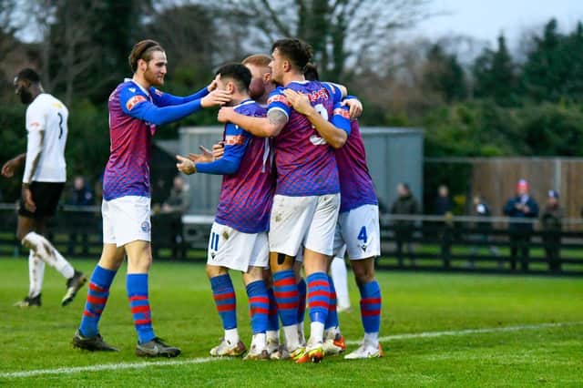 Ty Deacon celebrates with his AFC Rushden & Diamonds team-mates after he put them in front in the 2-1 victory at Royston Town. Pictures courtesy of Hawkins Images