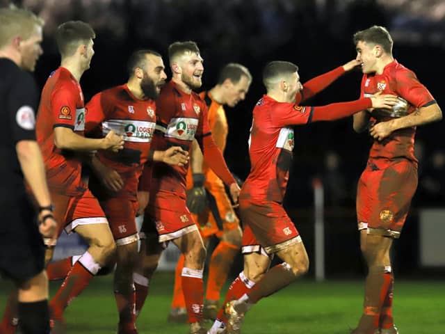 Harrison Neal takes the congratulations after he scored Kettering Town's third goal in their 3-1 success over Brackley Town at Latimer Park. Pictures by Peter Short