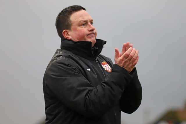 Kettering Town manager Paul Cox applauds his team from the sidelines during their fine 3-1 success over Brackley Town. Pictures by Peter Short