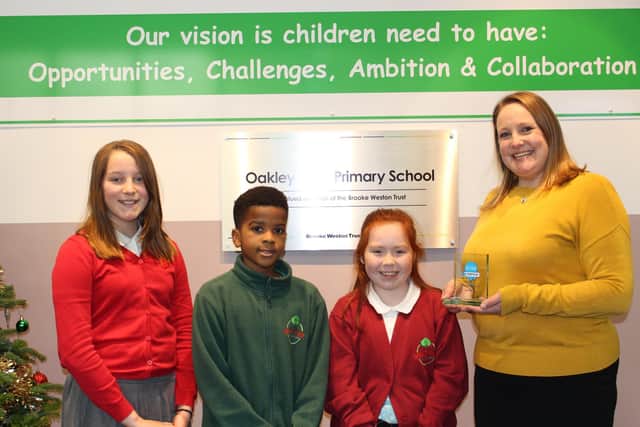 Vice principal of Oakley Vale Primary School, Becky Annetts with the award and pupils
