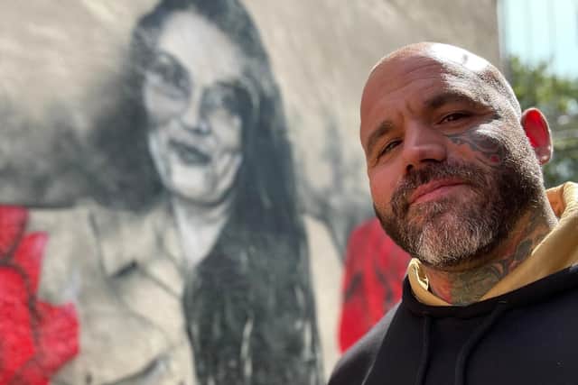 Aarron with the mural tribute to Tina 'Mental Mum'
