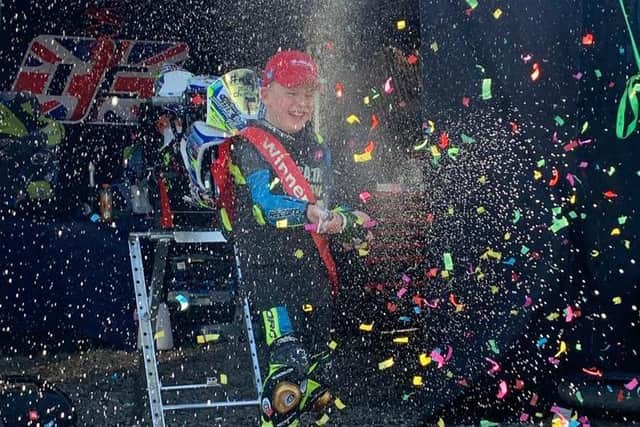 Oliver celebrates his win with Champagne