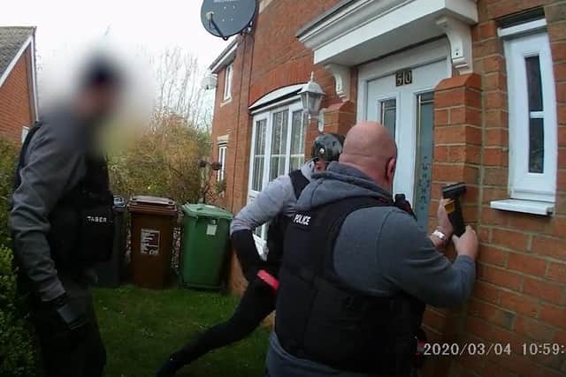 Officers break down the door of the house in Buttercup Close