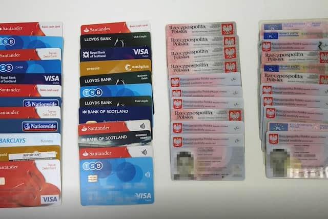 The bank cards and Polish identity documents found by police. They'd been used to launder hundreds of thousands of pounds.