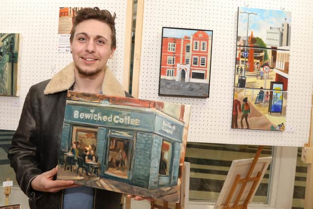 Daniel Kelly with his painting of Bewiched in the High Street