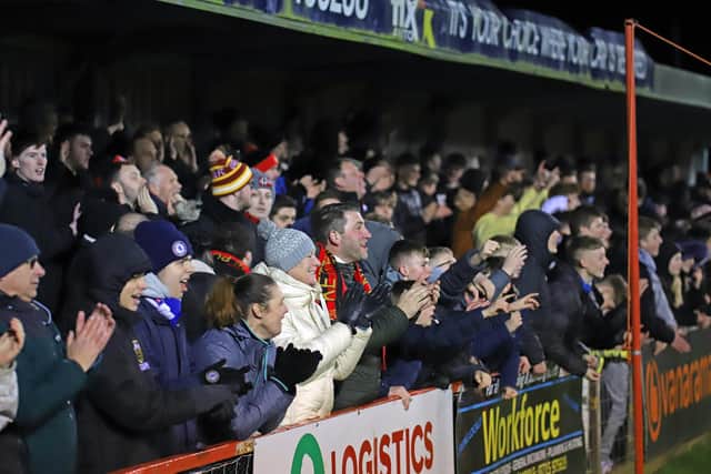 The Kettering Town fans celebrate at the final whistle after the 2-1 win over Southport on Tuesday night. Pictures by Peter Short