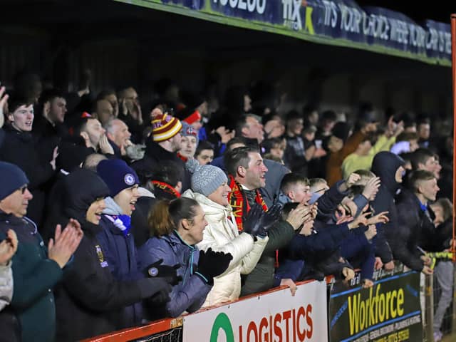 The Kettering Town fans celebrate at the final whistle after the 2-1 win over Southport on Tuesday night. Pictures by Peter Short