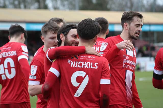 Crawley Town players celebrate with goalscorer Tom Nichols