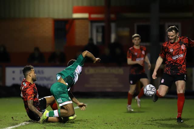 Kettering Town felt they should have been awarded a penalty for this challenge on Decarrey Sheriff during the 0-0 draw at Alfreton Town. Pictures by Peter Short