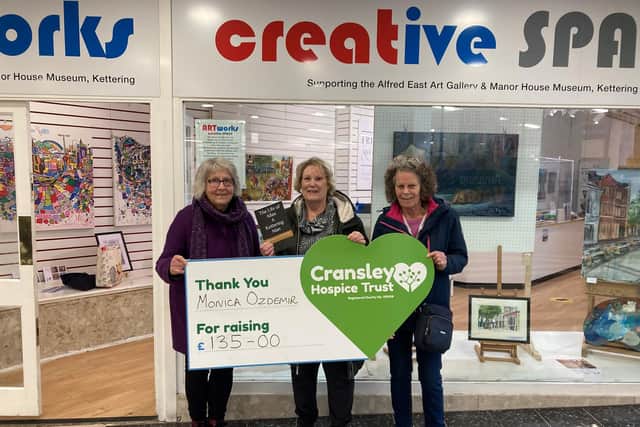 Monica Ozdemir hands over a cheque to Cransley Hospice