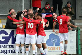 The Kettering Town players celebrate with the travelling fans after Callum Stead gave them an early lead in the 2-1 victory at Blyth Spartans. Pictures by Peter Short