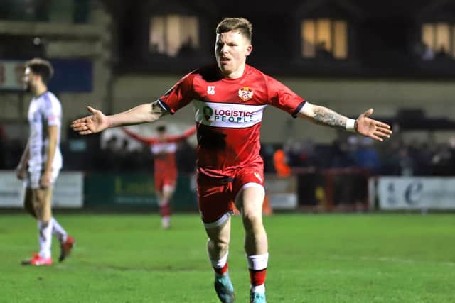 Jordon Crawford heads off to celebrate after he fired home Kettering Town's equaliser in the 2-2 draw with AFC Telford United at Latimer Park. Pictures by Peter Short