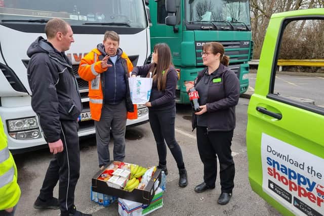 Staff from London Road Coop deliver a food parcel