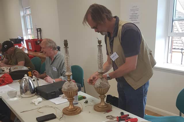 Volunteers working on items at a previous Repair Cafe