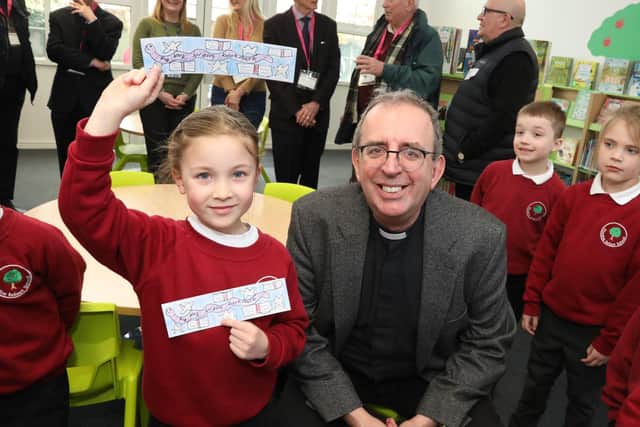 Winner of the book mark competition Charlotte Fox, 6,  with Rev Richard Coles in the newly refurbished and re-stocked Finedon Infant School library