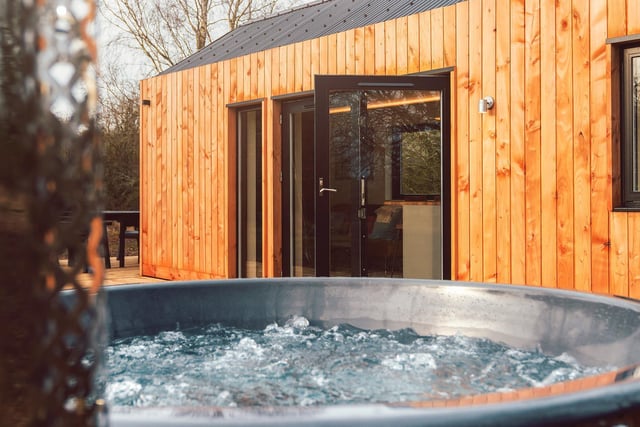Soak up your surroundings with the star of the show: the outside hot tub.