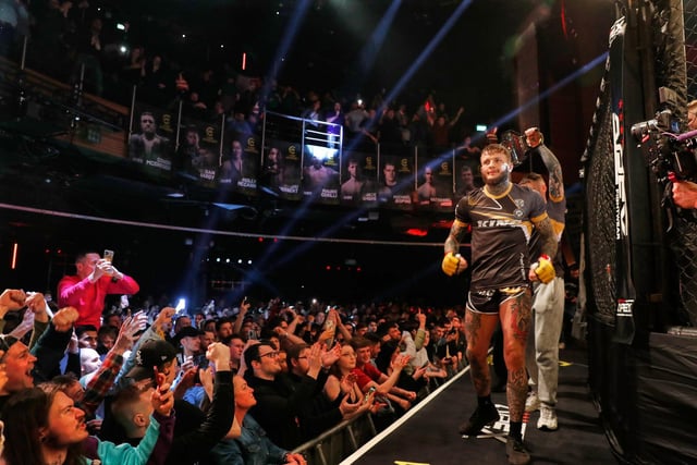 The defending champion makes his ring walk in London