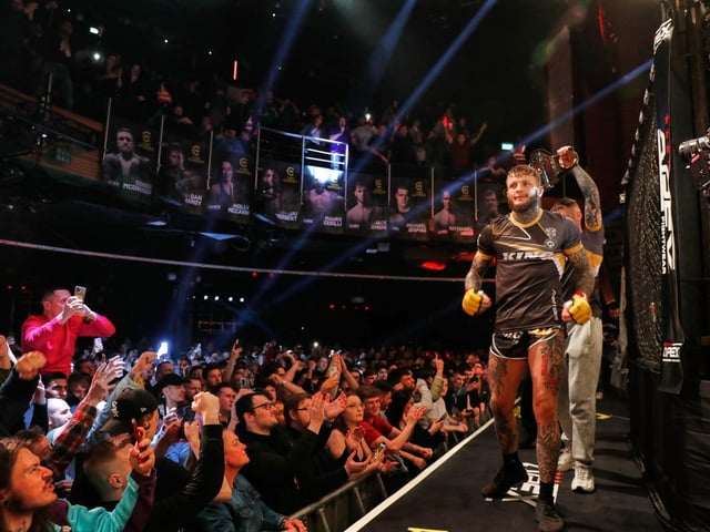 The defending champion makes his ring walk in London