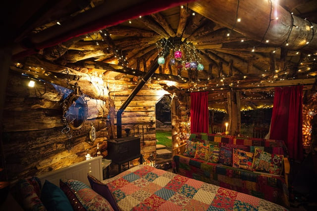 The decor uses bright, Indian patterns on the sofa beds, strings of fairylights, and bunches of lanterns.