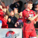 Connor Johnson, who scored the winning goal, applauds the Kettering Town fans after the 2-1 victory over Chorley. Pictures by Peter Short
