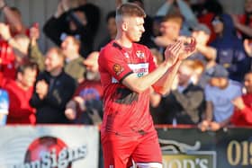 Connor Johnson, who scored the winning goal, applauds the Kettering Town fans after the 2-1 victory over Chorley. Pictures by Peter Short
