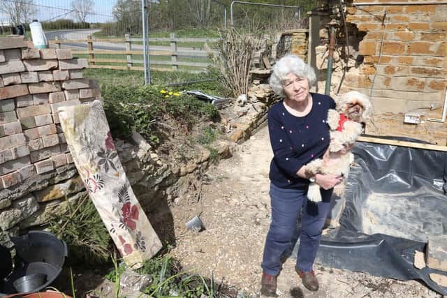 Ellen Keightley with her dog Bubbles standing in the area where the car landed