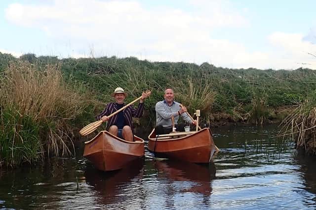 Giles Darby and Jon Wells in their homemade canoes