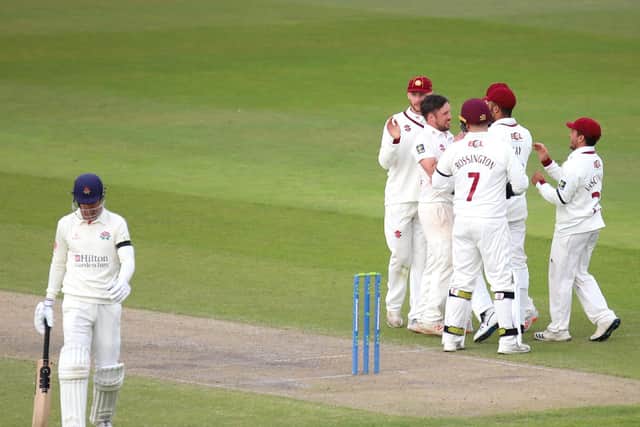 Simon Kerrigan is congratulated by his Northants team-mates after taking one of his three wickets against Lancashire (Pictures: Peter Short)