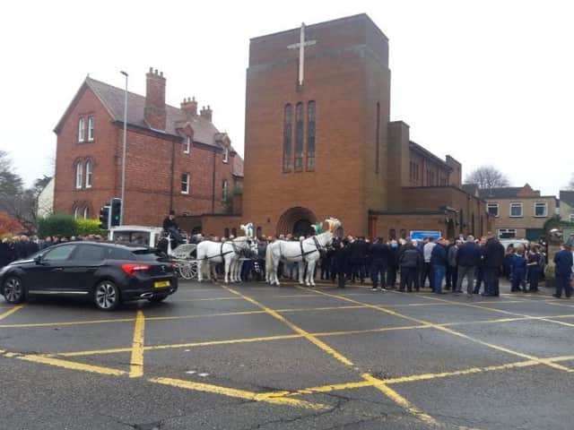 Mourners outside the funeral last year.