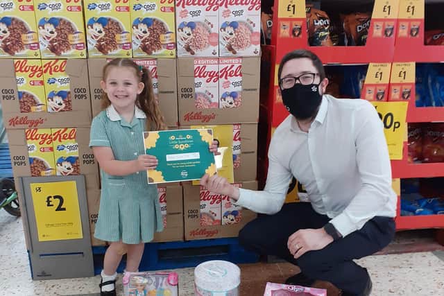 Hallie with Kettering Morrisons store manager Ben White.