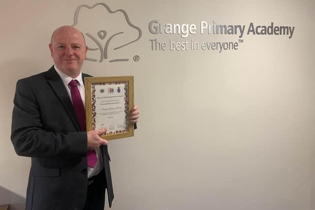 Chris Latimer, Grange Primary Academy headteacher, with award